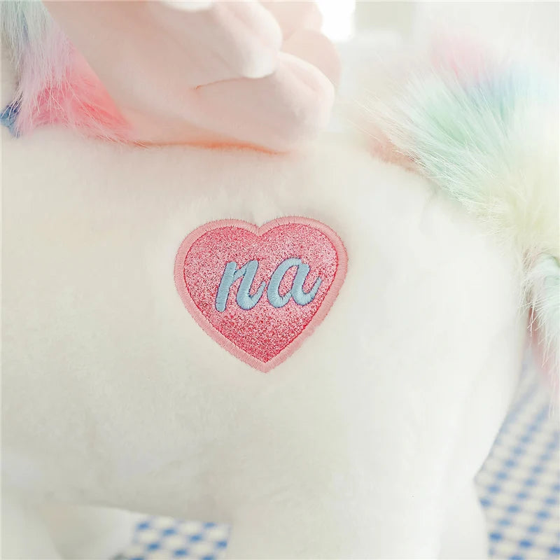 Peluche licorne blanche étoilée avec ailes et corne dorée