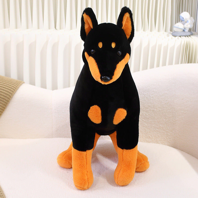 Peluche chien doberman noir et marron assis