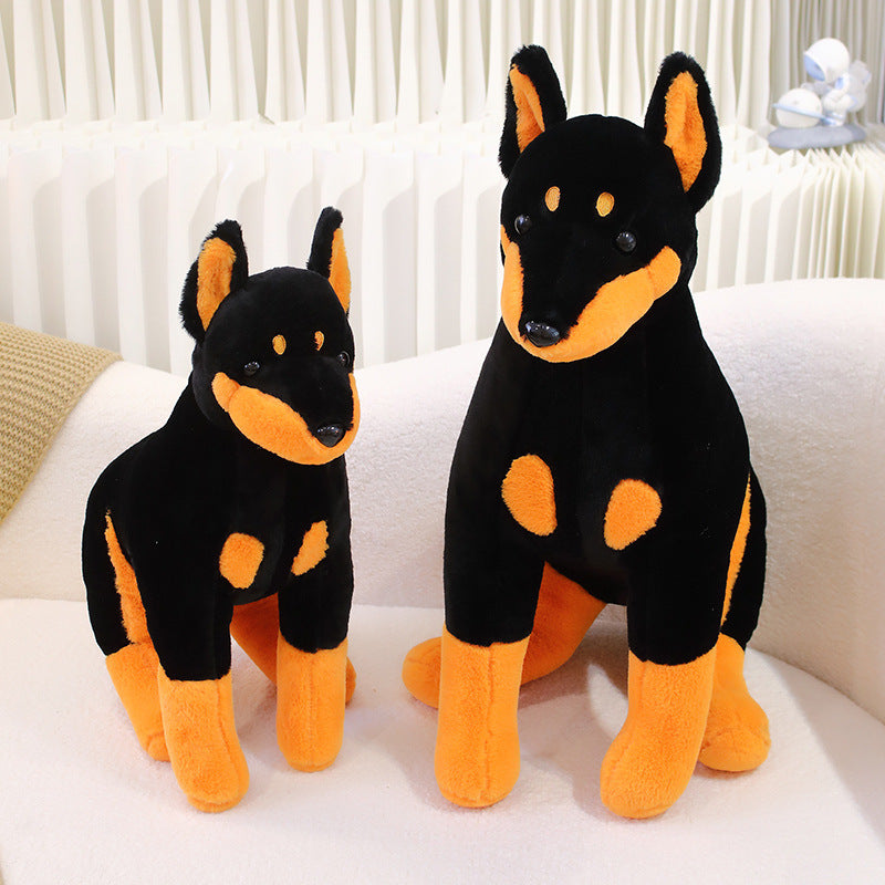 Peluche chien doberman noir et marron assis