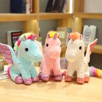 Peluche licorne rose à crinière arc-en-ciel magique
