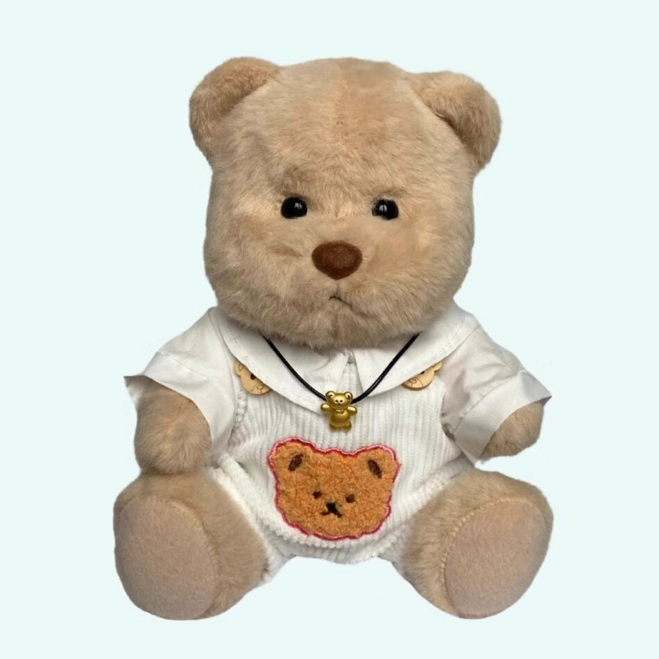 Ours en peluche en combinaison blanche