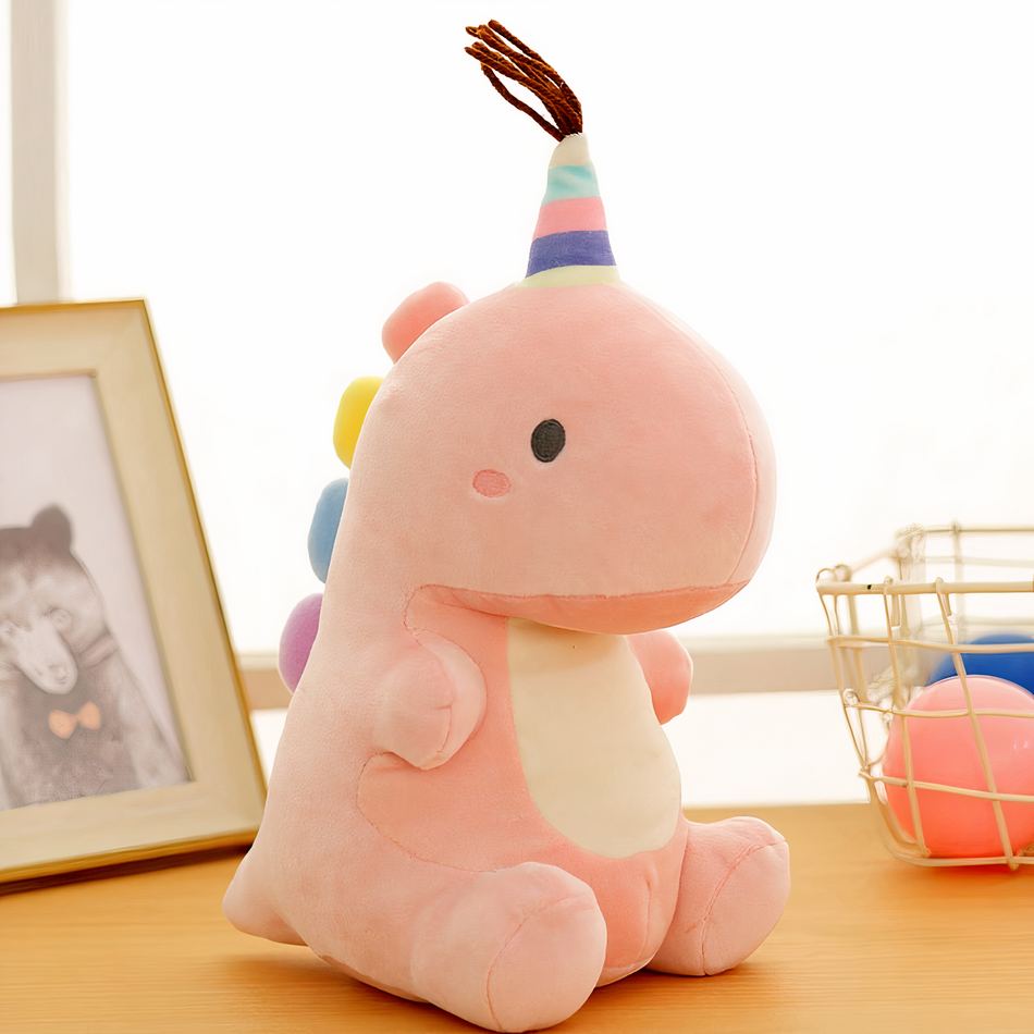 Peluche dinosaure queue arc-en-ciel douce câline 23cm / rose La compagnie de la peluche