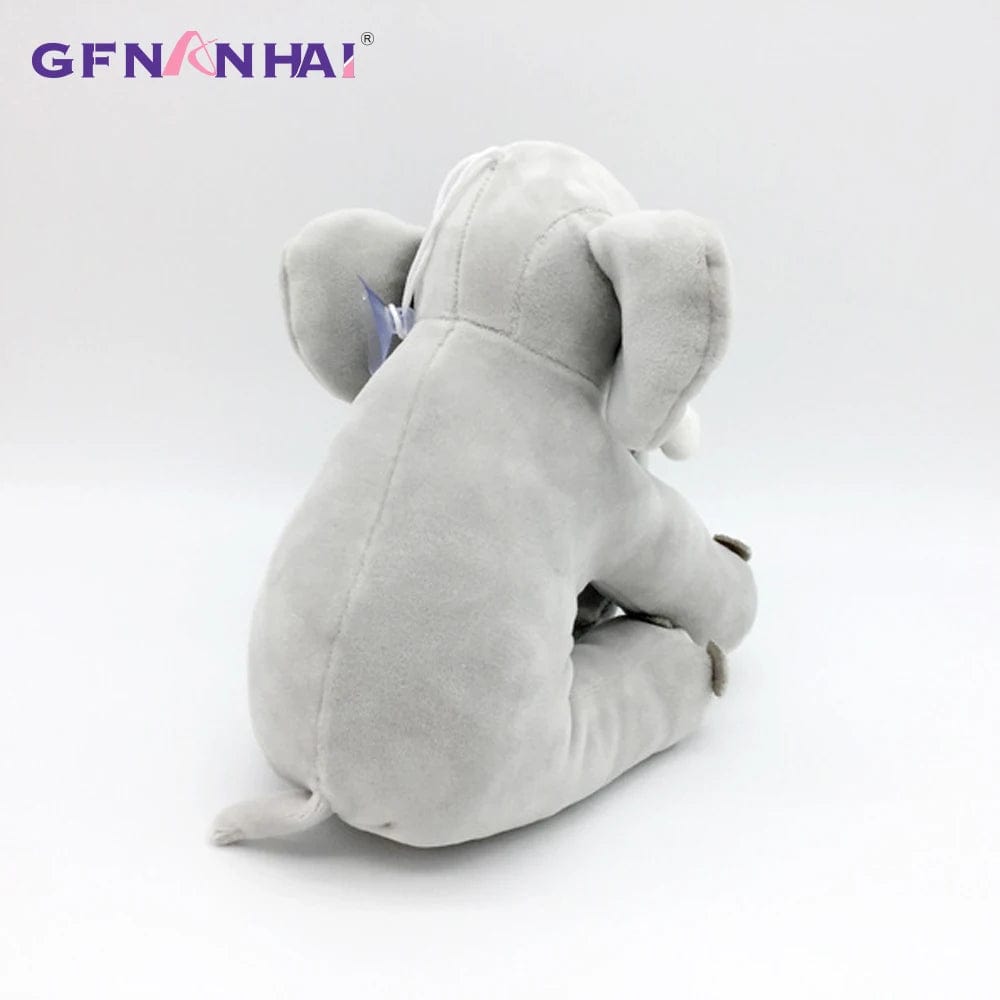 Peluche éléphant assis et content