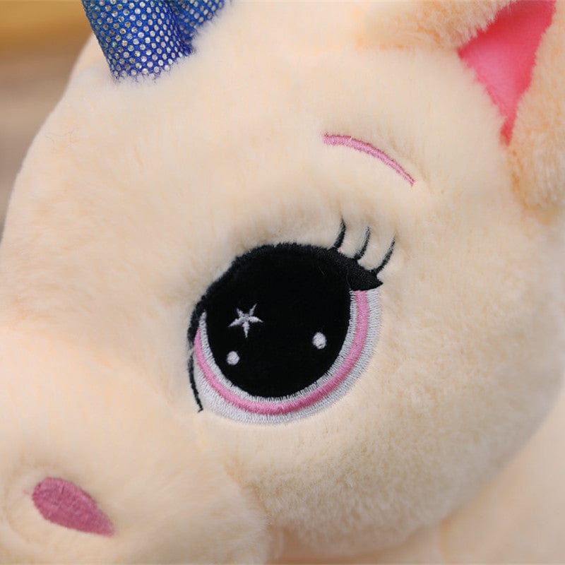 Peluche licorne avec des etoiles dans les yeux