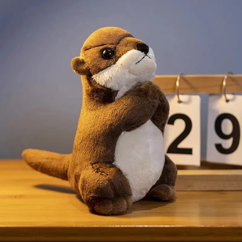 Peluche loutre aux mains jointes