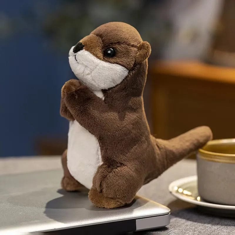 Peluche loutre aux mains jointes