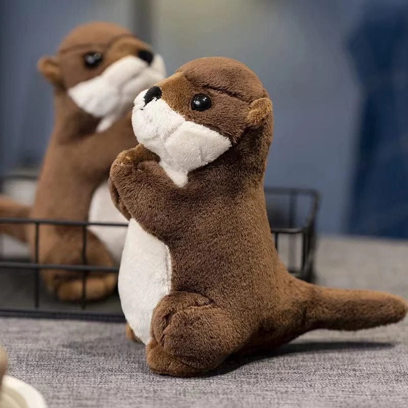 Peluche loutre aux mains jointes