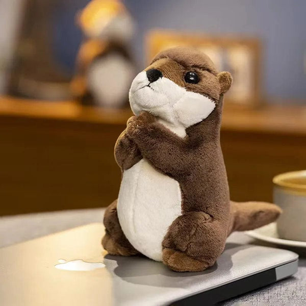 Peluche loutre aux mains jointes