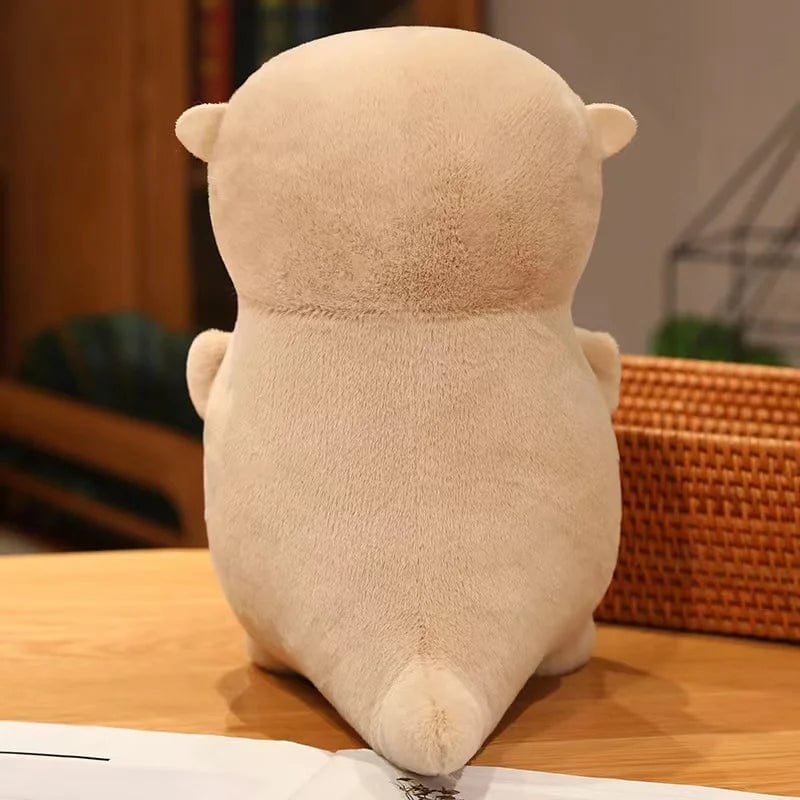 Peluche loutre tenant un poisson