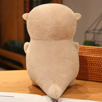 Peluche loutre tenant un poisson