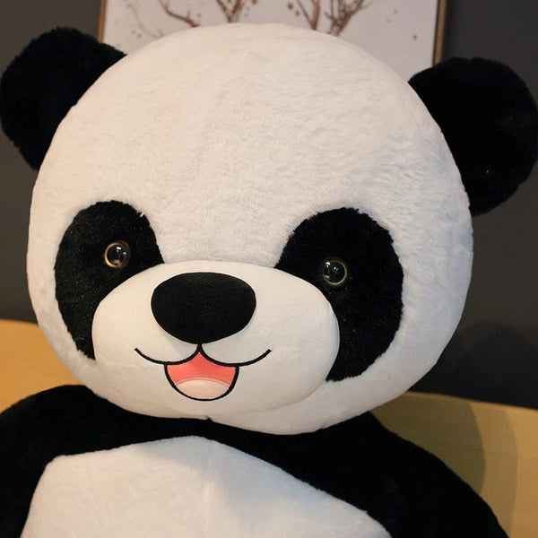 Peluche panda géant avec une fleur