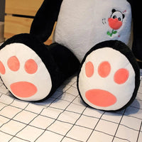 Peluche panda géant avec une fleur